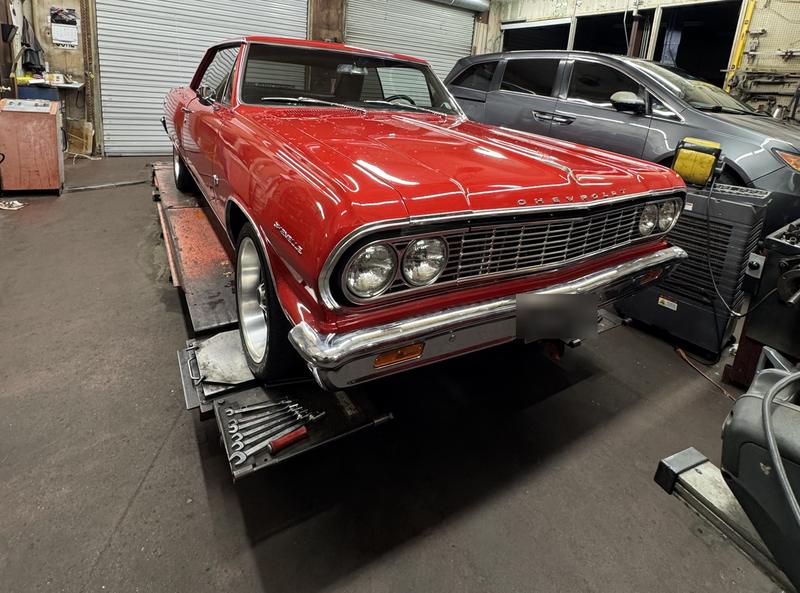 Red classic Chevrolet Chevelle on the alignment rack