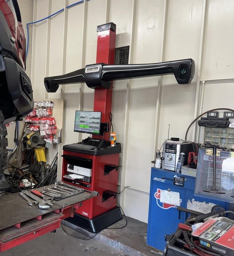 Hunter alignment machine with camera bar and computer console in the shop